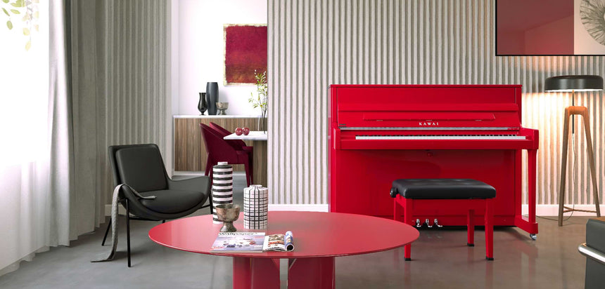 Kawai K-200 upright piano in polished red – front view in a living room with black piano bench.