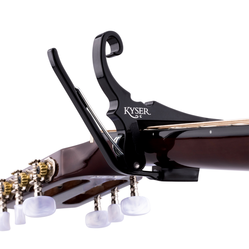 Black Kyser Quick-Change capo for classical guitar, close-up on the neck