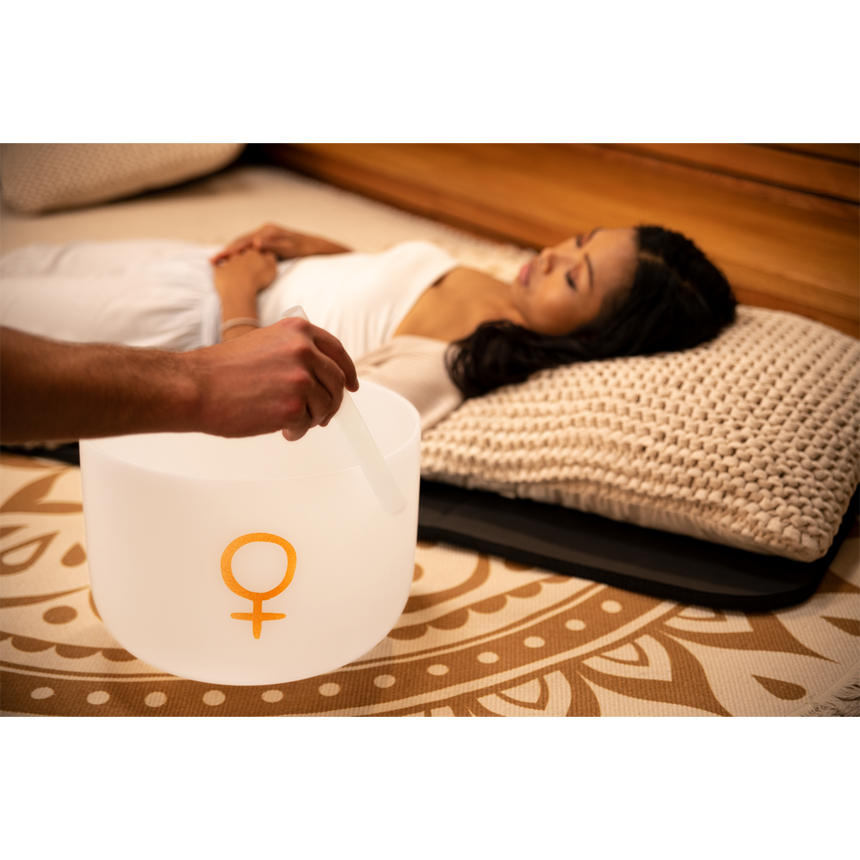 Meinl Sonic Energy PCSB12V, white frosted, golden Venus symbol – singing bowl beside a resting person